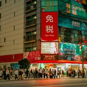 Vivid city lights illuminate bustling streets in Tokyo's Akihabara at night.